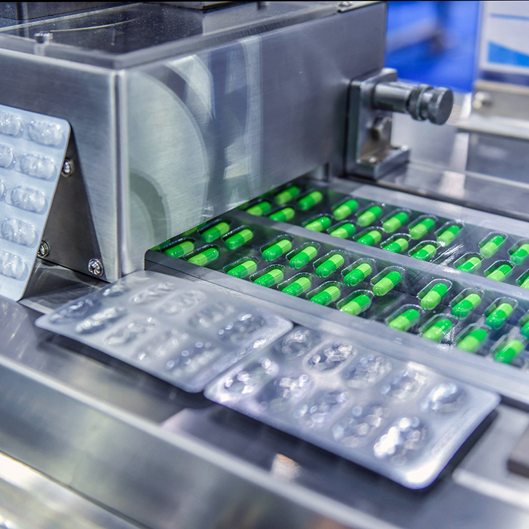 Green capsule medicine pill production line, Industrial pharmaceutical concept.