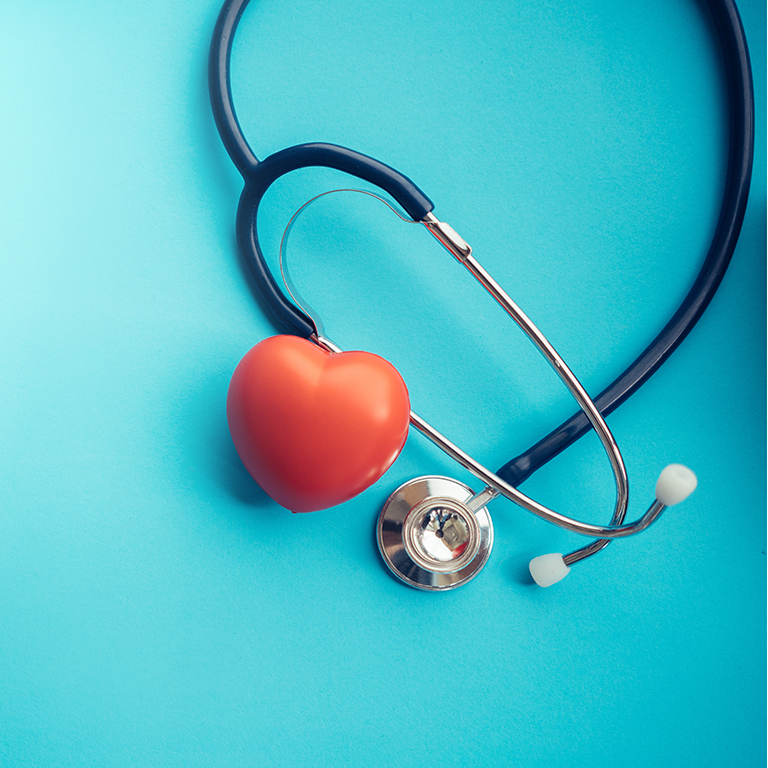 Red rubber heart next to stethoscope