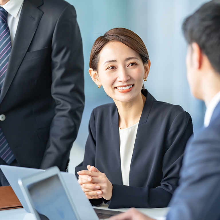 Asian business meeting over laptops with documents