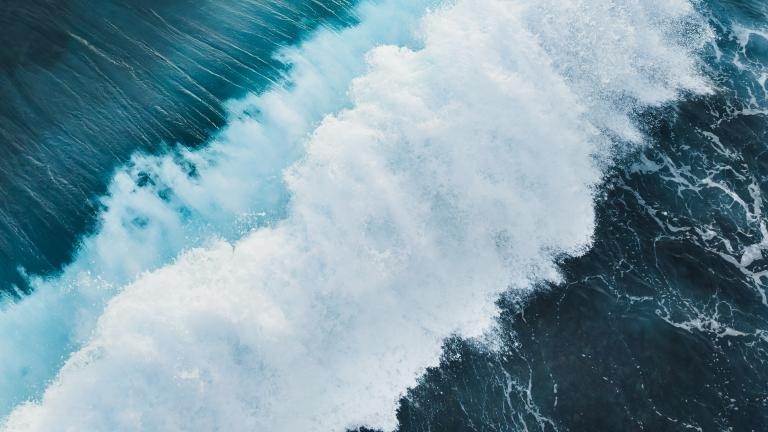 Ocean waves crash against the shore