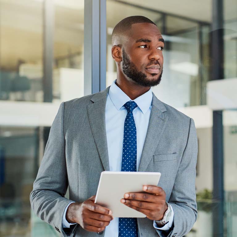 Shot of a young businessman using a digital tablet in an office