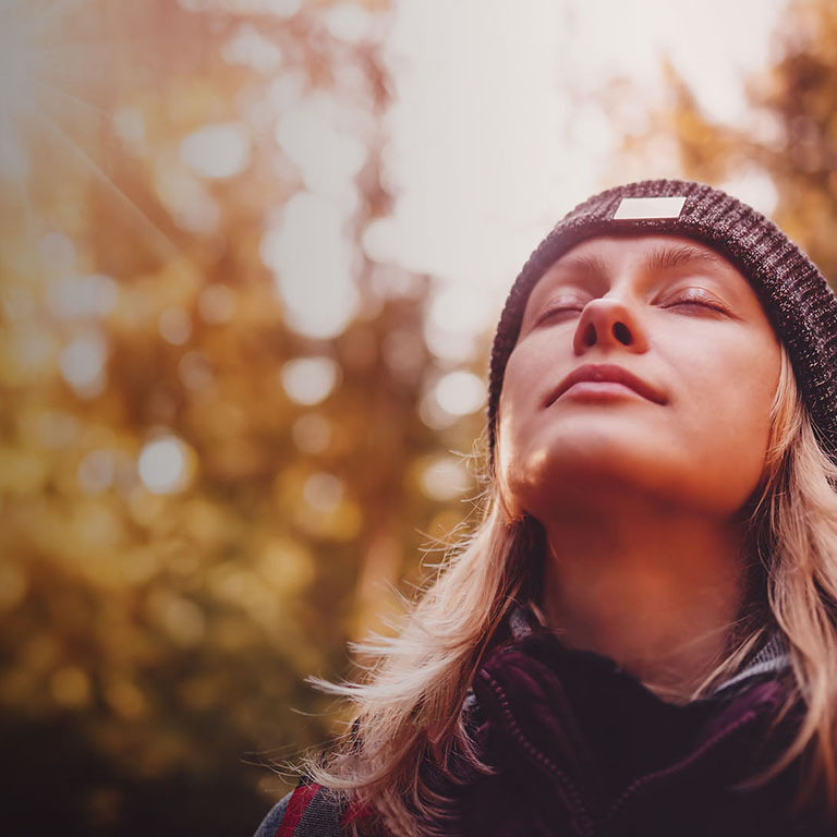 Young woman hiking and going camping in nature. Person with backpack walking in the forest