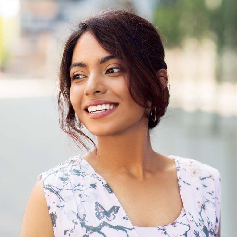 Happy smiling Indian woman outdoors