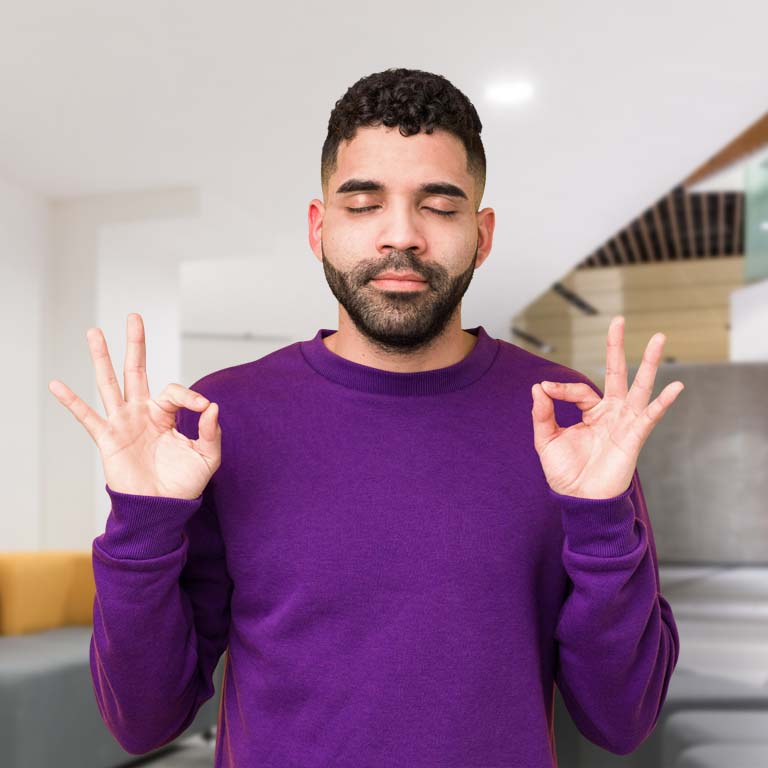 Young mixed race arabic man isolated relaxes after hard working day, she is performing yoga.