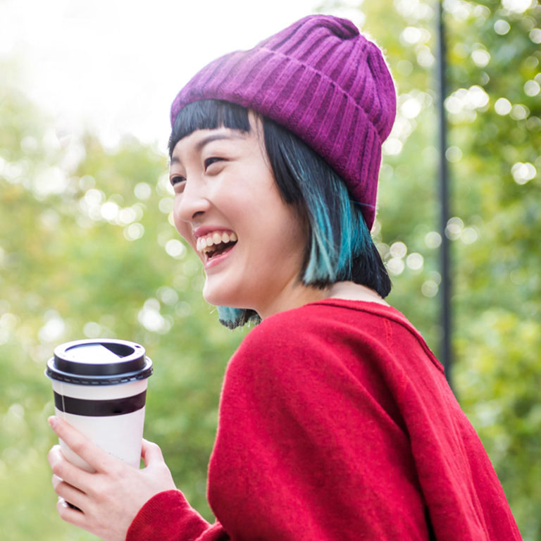 young stylish women laughing in city park