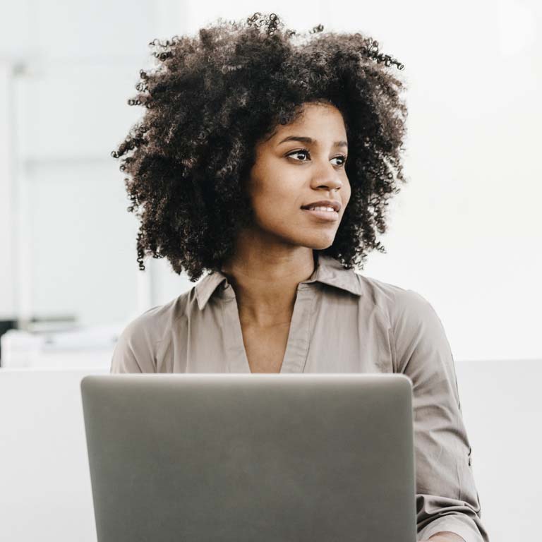 young woman using laptop in office