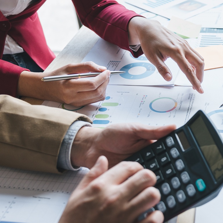 Teamwork of asian business people discussing and calculating with calculator on evaluation data in conference room. with the growth and pointing to the chart graph financial account.