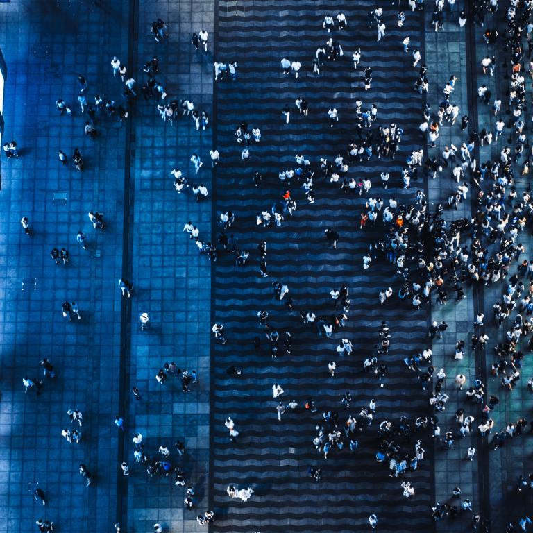 Busy urban street with people walking at night
