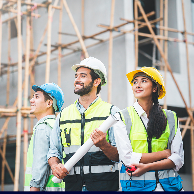 Happy and sucessful construction team standing with confident outdoor at construction site