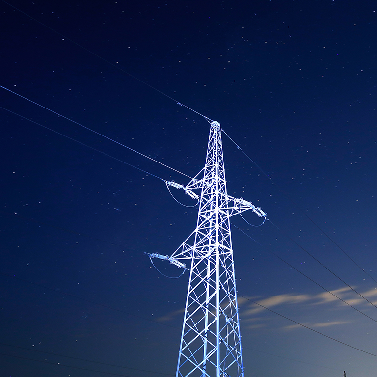 Pylon for electricity distribution at night with starry sky