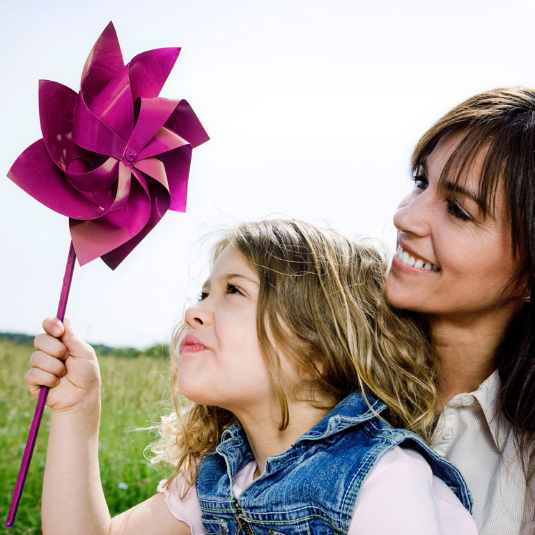 Woman and girl with toy windmill, Paty, Hungary