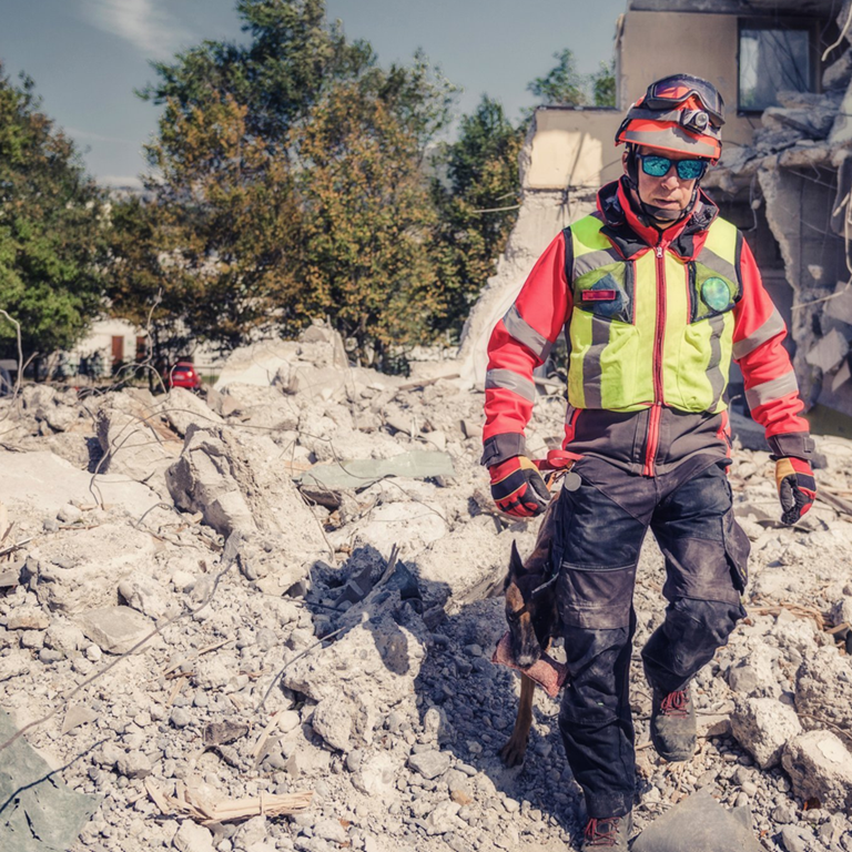 A rescuer inspects the ruins