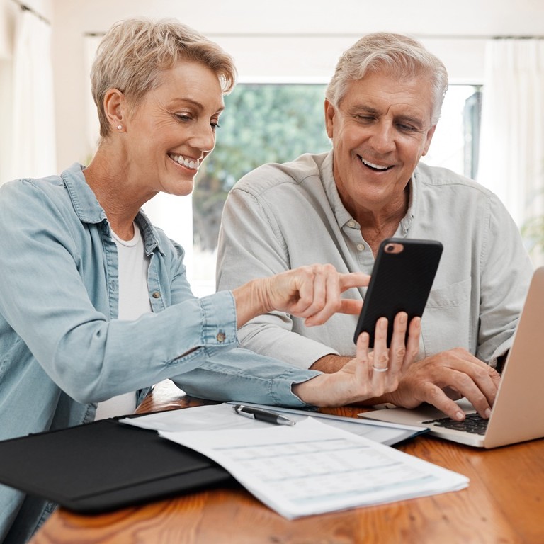 A senior couple working with documents