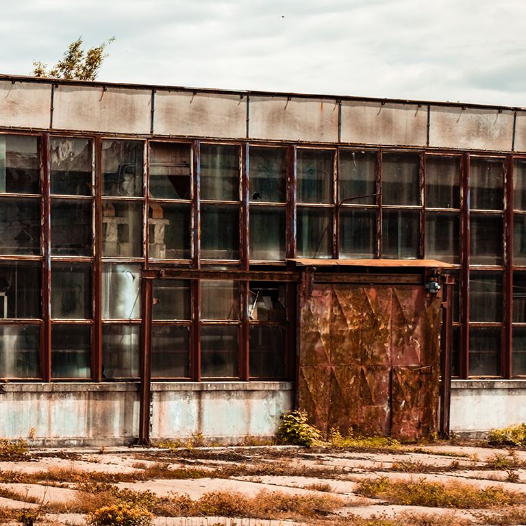 abandoned factory warehouse with broken windows