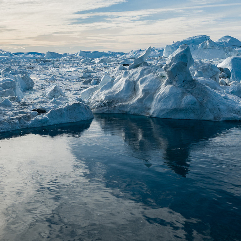 Drone photo of Iceberg and ice from glacier in arctic nature landscape on Greenland. Aerial photo drone photo of icebergs in Ilulissat icefjord. Affected by climate change and global warming.