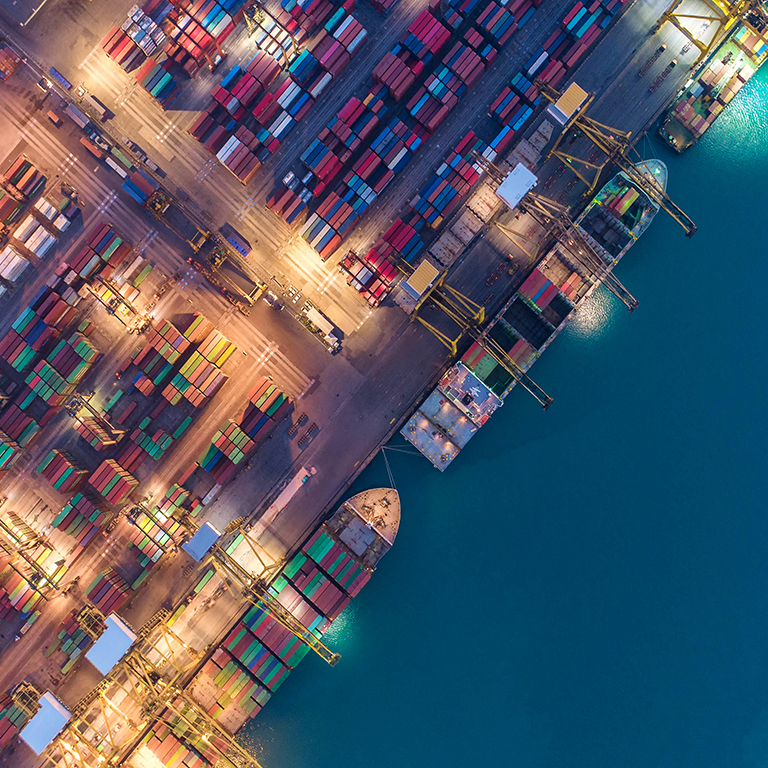 Container ship in export and import business and logistics. Shipping cargo to harbor by crane. Water transport International. Aerial view