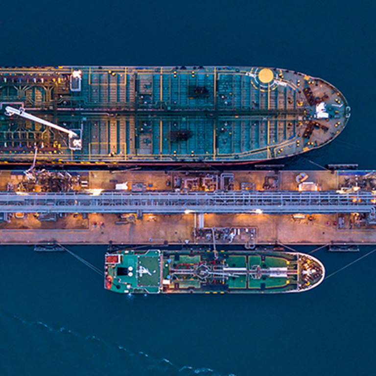 Aerial view oil ship tanker carrier oil at terminal sea port, Large crude oil tanker unloading at port, Business import export oil and gas petrochemical with tanker ship transportation oil from dock refinery.