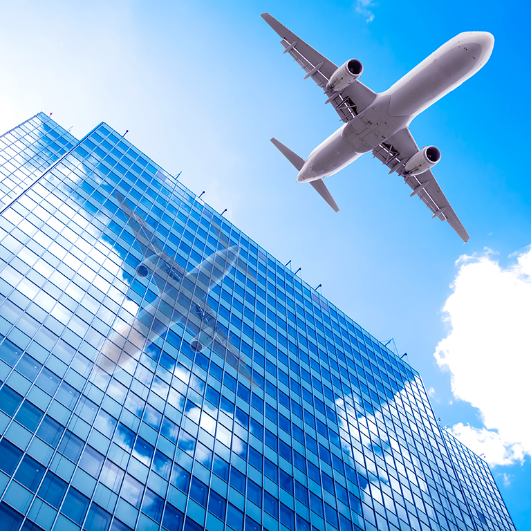 aeroplane flying over the skyscrapers. architecture building with flying airplane