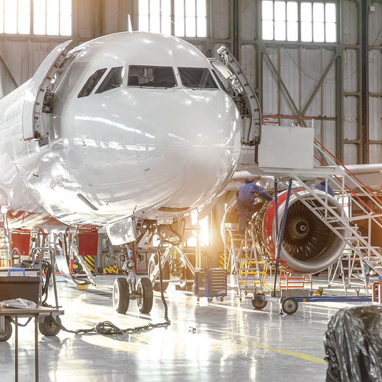 Aircraft jet on maintenance of engine and fuselage check repair in airport hangar