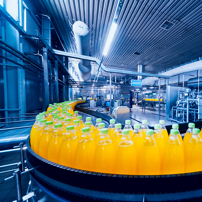 Beverage factory interior. Conveyor with bottles for juice or water. Modern equipments