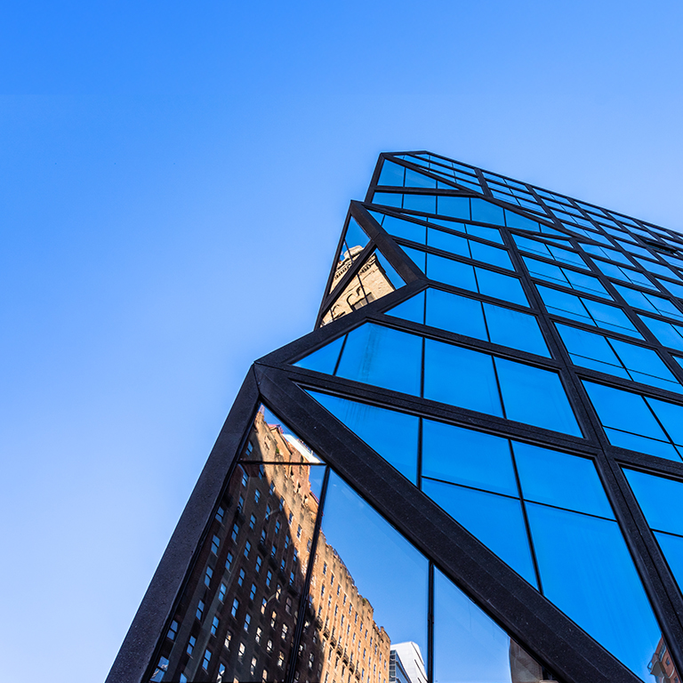 Blue glass wall and sun reflections