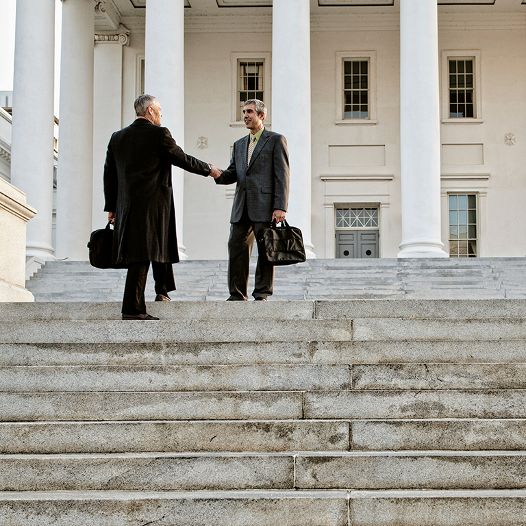 Businesss meeting on steps of government building