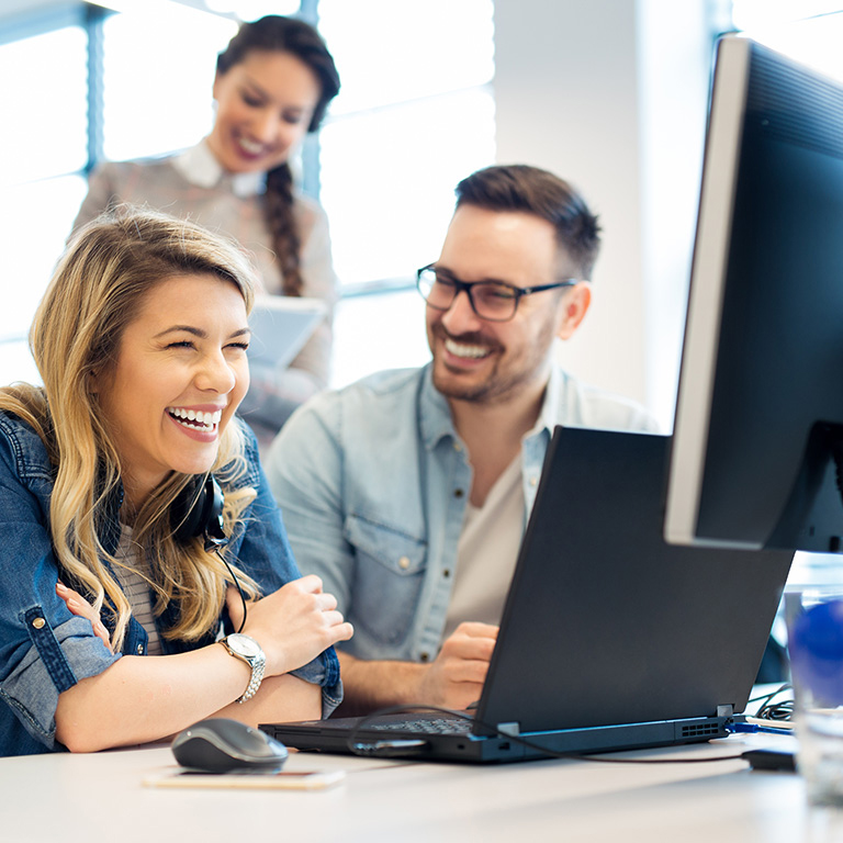 Business people working on computers as a team in office