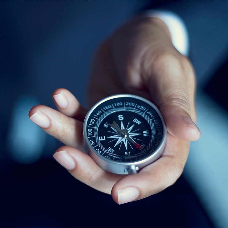 Business person holding a compass