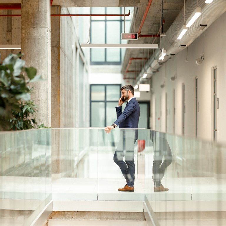 Business professional talks on phone in modern office space