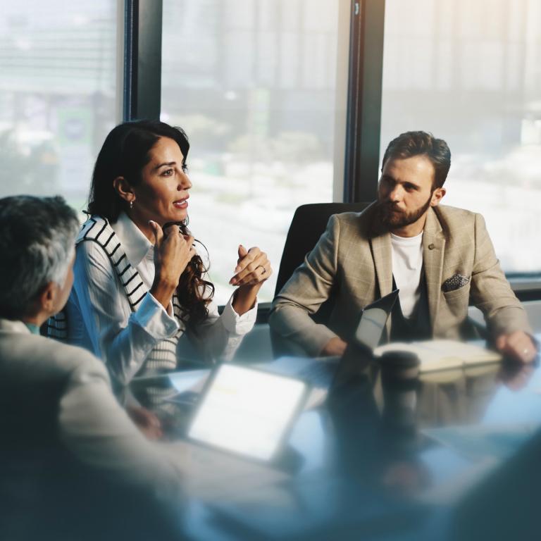 Business professionals discussing strategy during office meeting