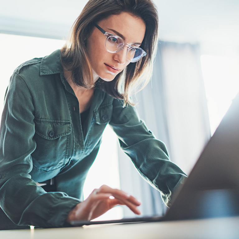 Portrait of Young handsome businesswoman using laptop computer at modern office.Blurred background