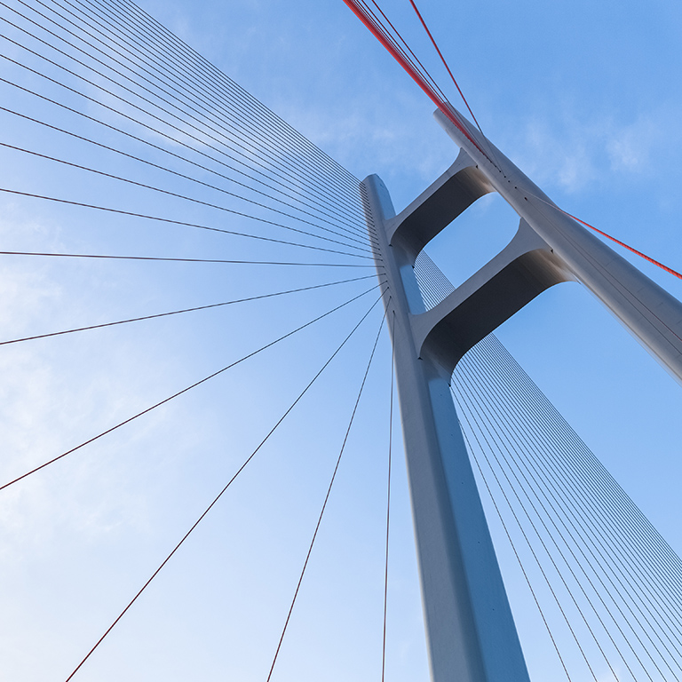 cable stayed bridge closeup against blue sky , upward view