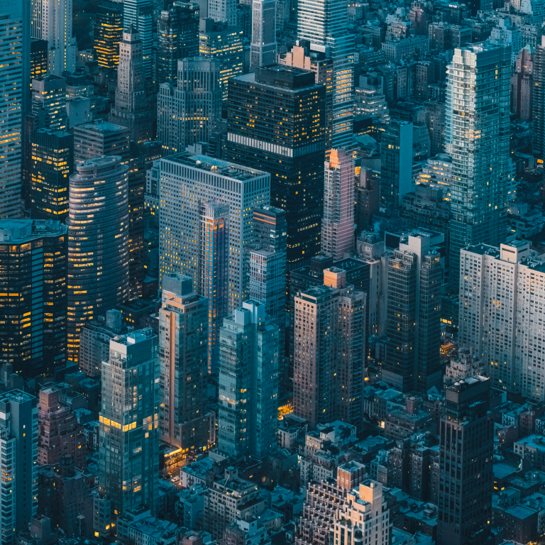 City skyline shows buildings and lights in the evening