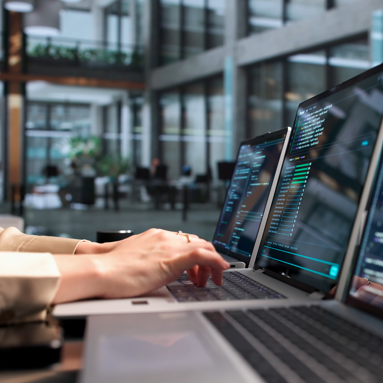 Close-up of a software developer typing code on a keyboard