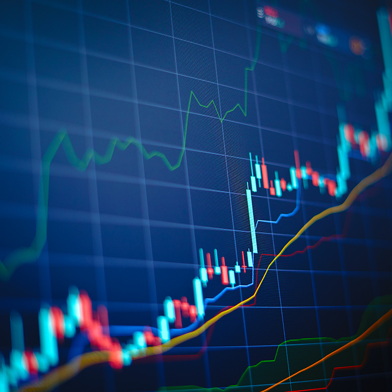 Closeup financial chart with uptrend line candlestick graph in stock market on blue color monitor background