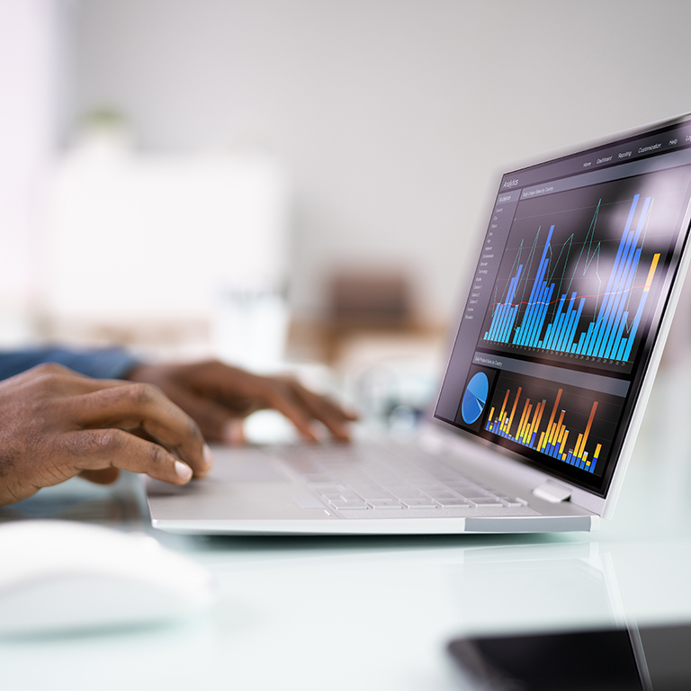 Digital Data Technology. KPI Business Dashboard Technology. Close up of hands on laptop, screen showing analytics.