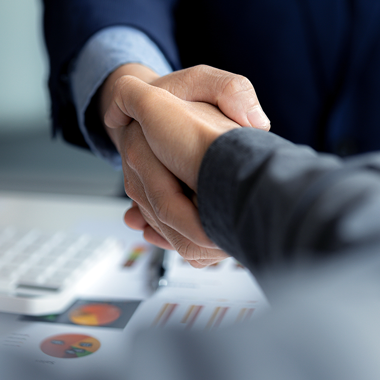 Close-up two businessmen shaking hands after a successful negotiation.