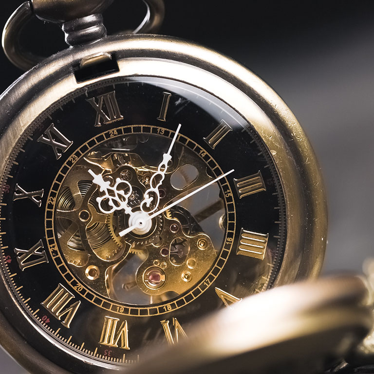 Antique old pocket watch dial close-up. Vintage hipster clock measuring time.