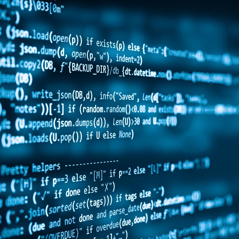 Code running on computer screen in a dark room