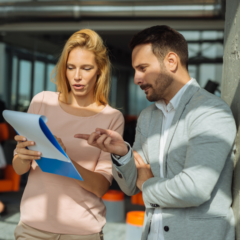 Colleagues discussing notes in office