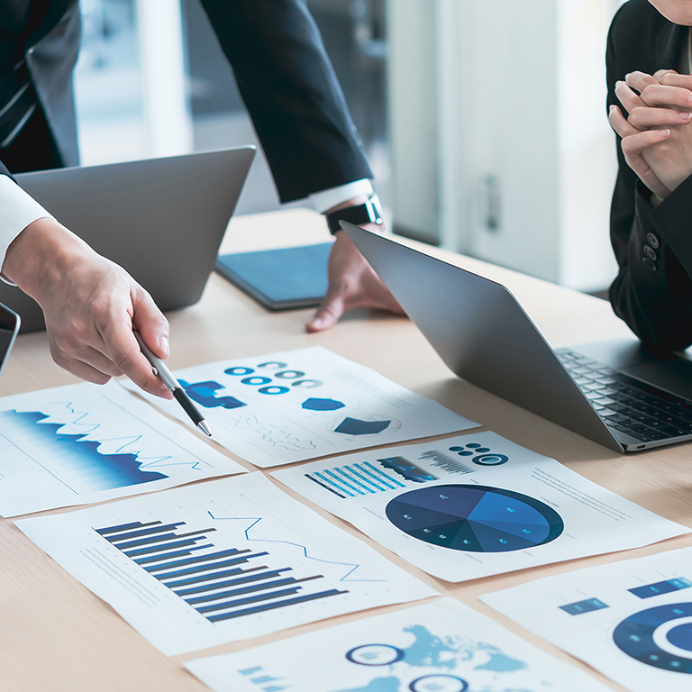 Colleagues looking at analytics and charts in an office