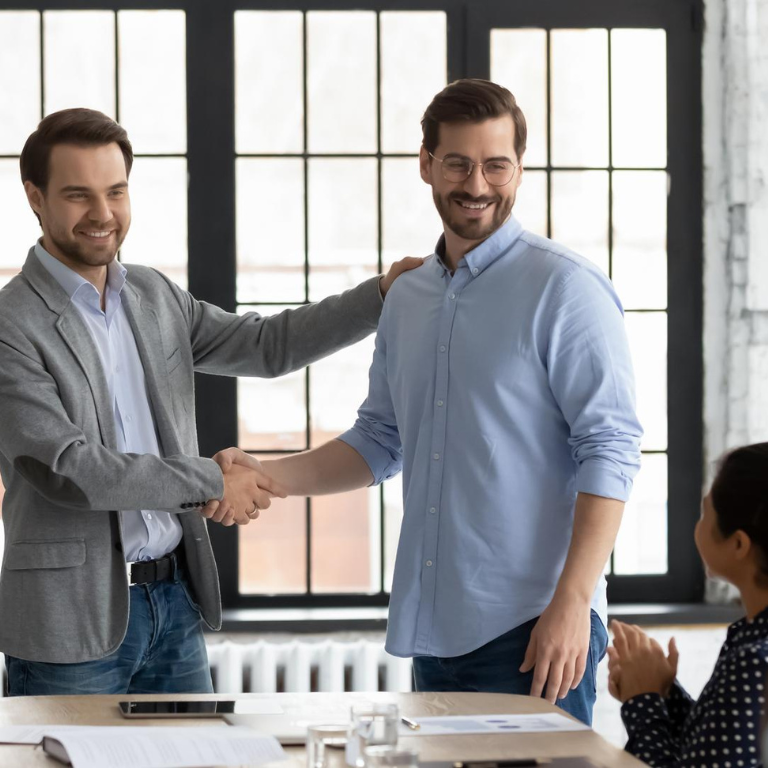Colleagues shake hands on the meeting