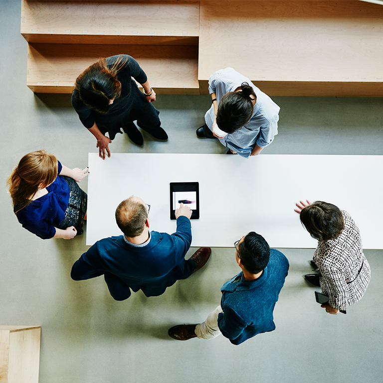 Over the top view of a team reviewing a document.