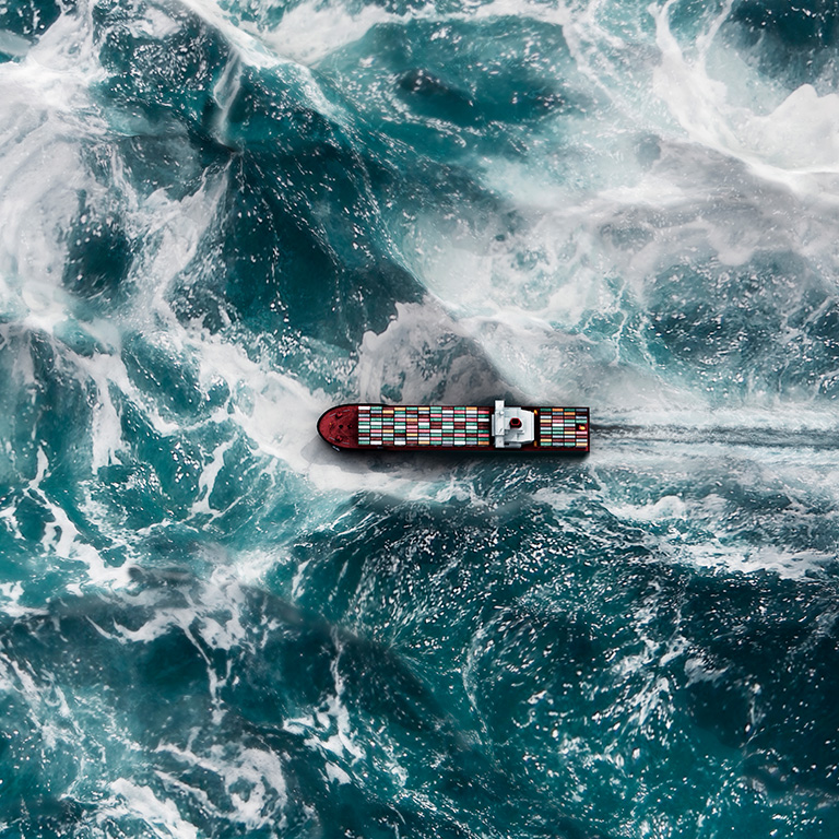 Container ship navigating through turbulent waters
