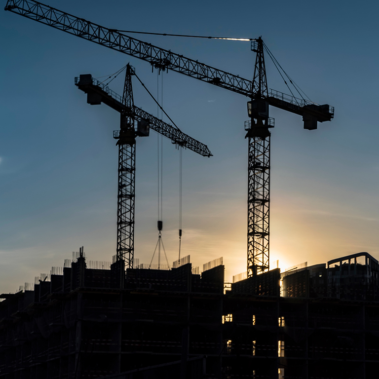 Cranes working day and night on construction of the housing estate in former industrial zone