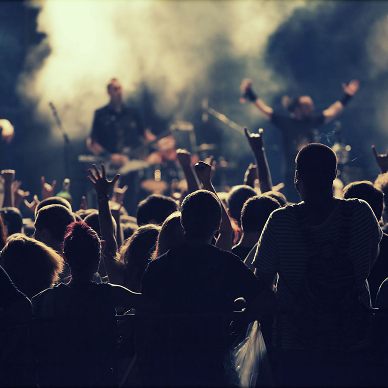 Crowd at concert and spectacular stage lights