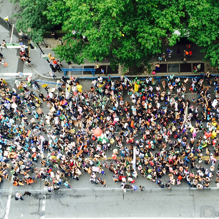 Aerial view of crowd marching protest on the street.
