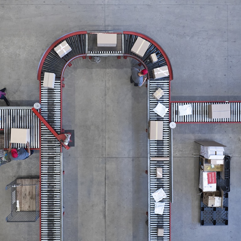 Delivery packages move on conveyor belt in sorting center