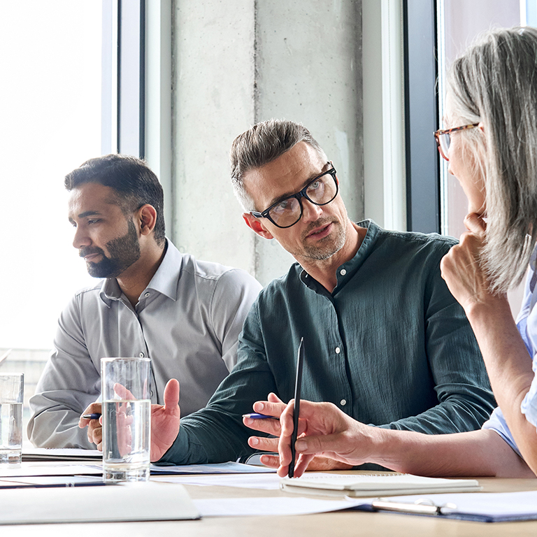 Diverse business people partners group negotiating at boardroom meeting.Multiethnic executive team discussing financial partnership agreement project strategy brainstorming sitting at table in office.