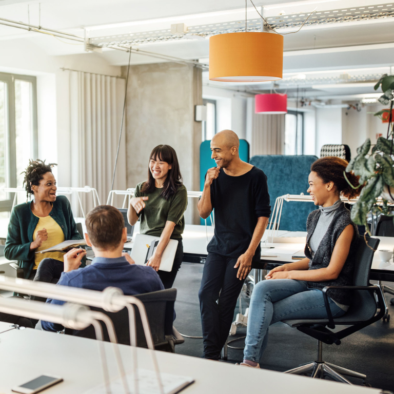 Happy multi-ethnic people discussing in meeting at creative office